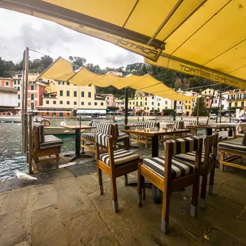 Portofino, Italie - 12-29-2023: the quays of Portofino's typical little port, with the terraces of the restaurants set up along the water's edge., License Type: media, Download Time: 2025-10-07T17:37:14.000Z, User: Sarahstocking, Editorial: true, purchase_order: 65050 - Digital Destinations and Articles, job: Digital, client: Guide to Portofino, other: Sarah Stocking