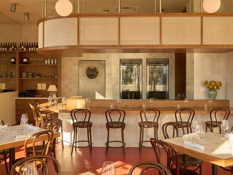 The bar at an empty restaurant decorated in earth tones