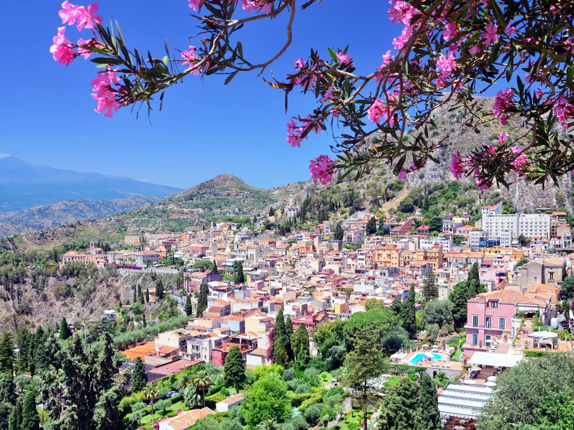 Taormina, a hilltop town on Sicily's east coast, with Mt Etna partially visible in the distance. Getty Images/iStockphoto