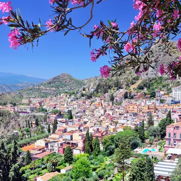 Taormina, a hilltop town on Sicily's east coast, with Mt Etna partially visible in the distance. Getty Images/iStockphoto