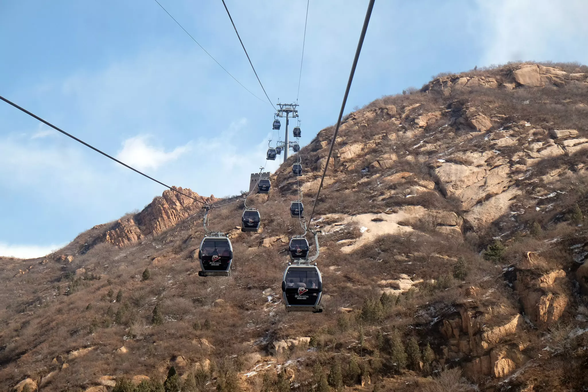 Cable cars traveling up to one of the towers at the Great Wall section at Badaling. Zvonimir Atletic/Shutterstock