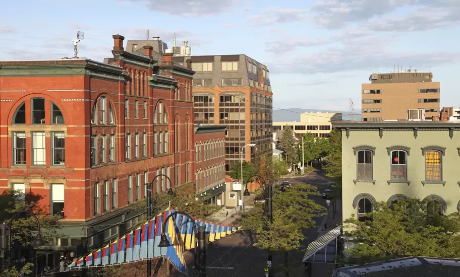 Church Street in downtown Burlington, Vermont, red-brick Victorian buildings and striped banners above the street