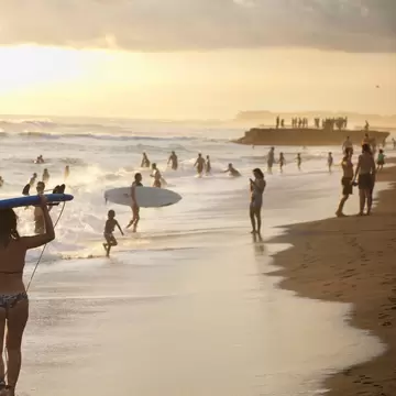 **RIghts Managed** uploaded for use on the LP app
Beachgoers and surfers on Nelayan Beach at sunset, North of Kuta, Bali, Indonesia