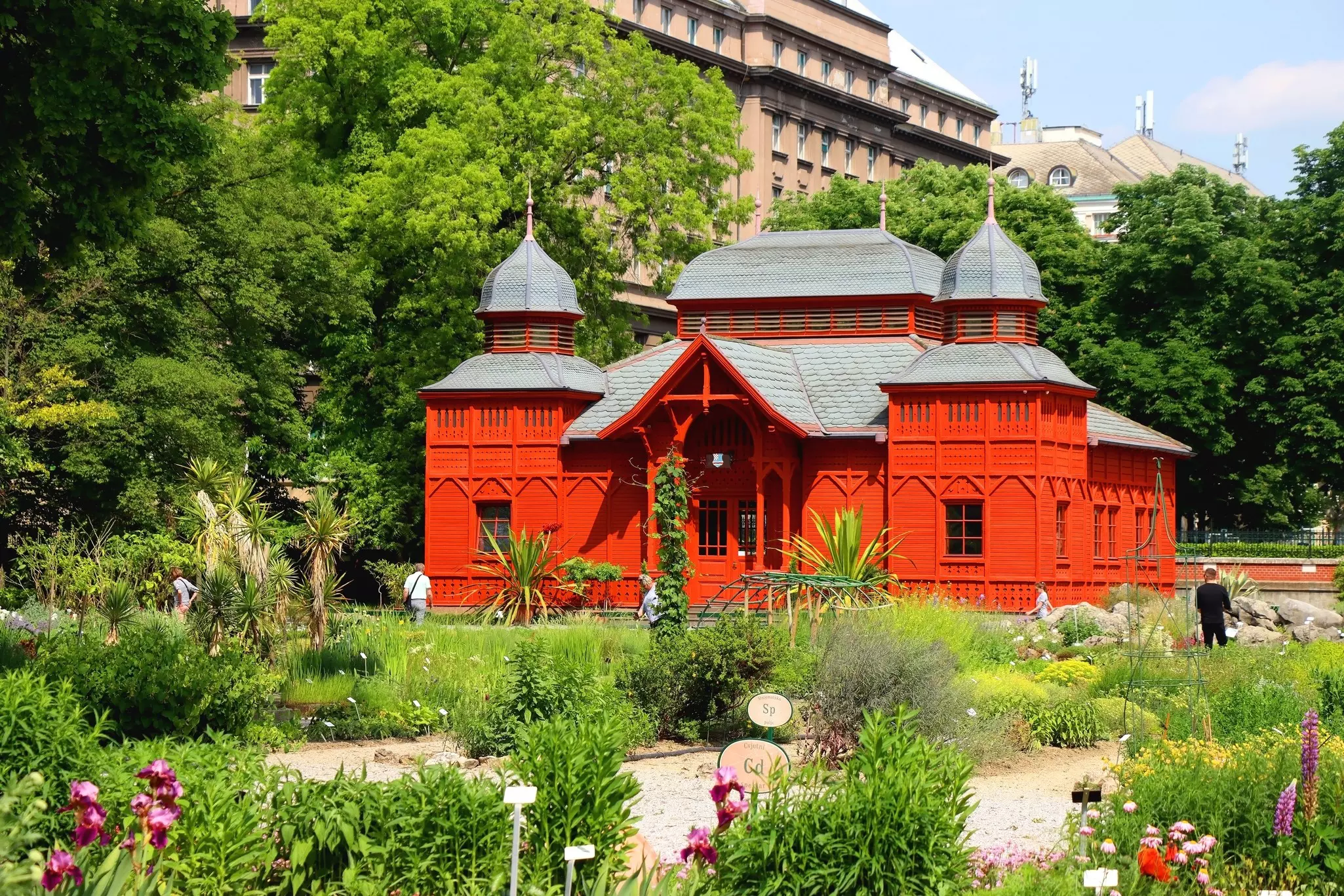 Historic red pavilion and colorful flowers in the Botanical Garden in Zagreb, Croatia.