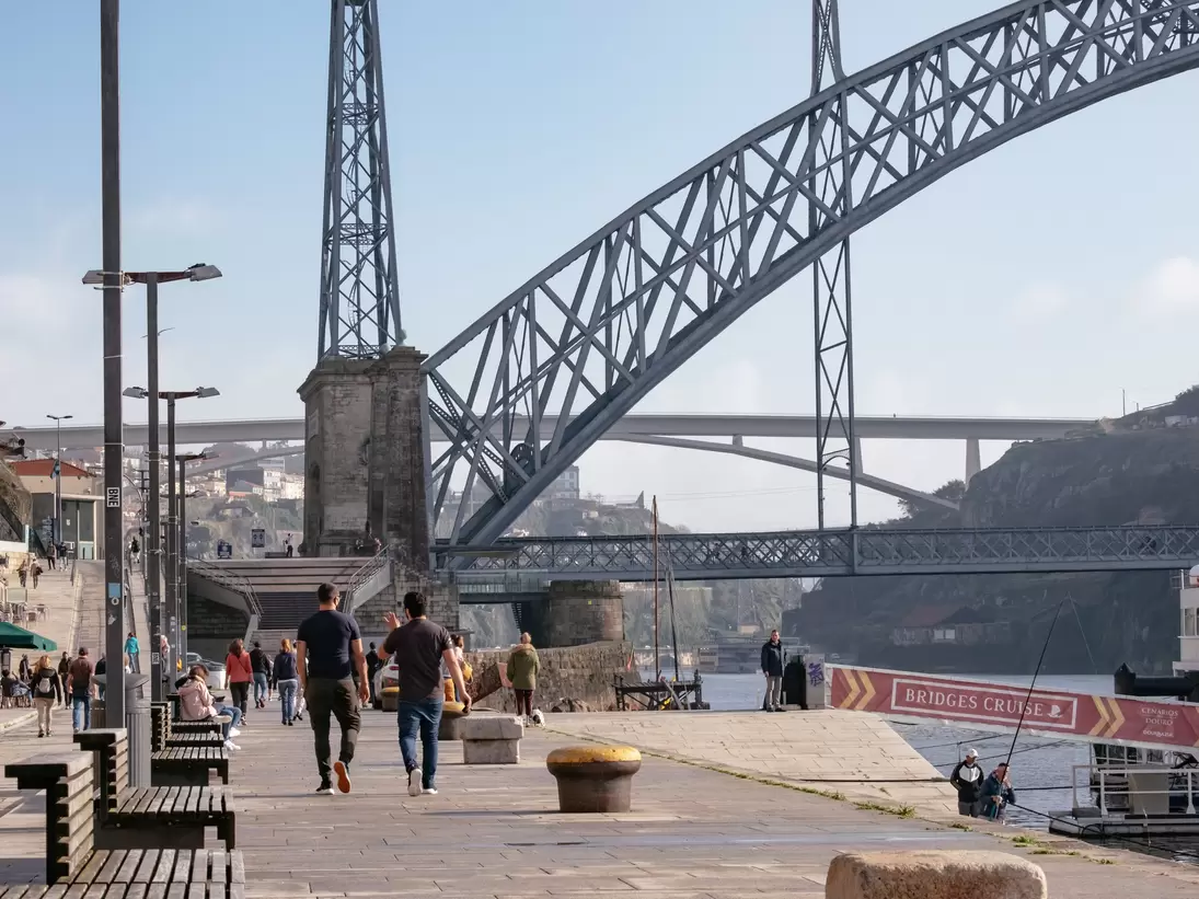 PORTO, PORTUGAL â€“ DEZEMBER, 12 2020: People Walking in "Ribeira" riverside with Iron "Dom LuÃ­s" Bridge - Autumn Day  License Type: media  Download Time: 2021-11-22T08:13:03.000Z  User:   Is Editorial: Yes  purchase_order:   