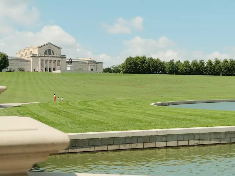 A large beaux-arts building in parkland