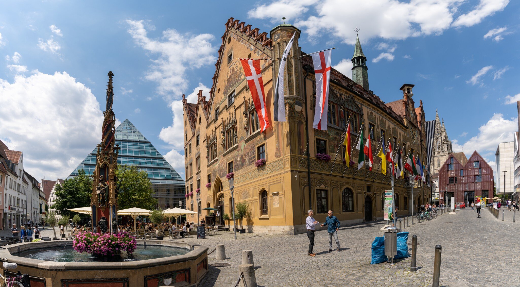 Ulm, BW / Germany - 14 July 2020: view of the town square in historic Ulm with people enjoying a day out