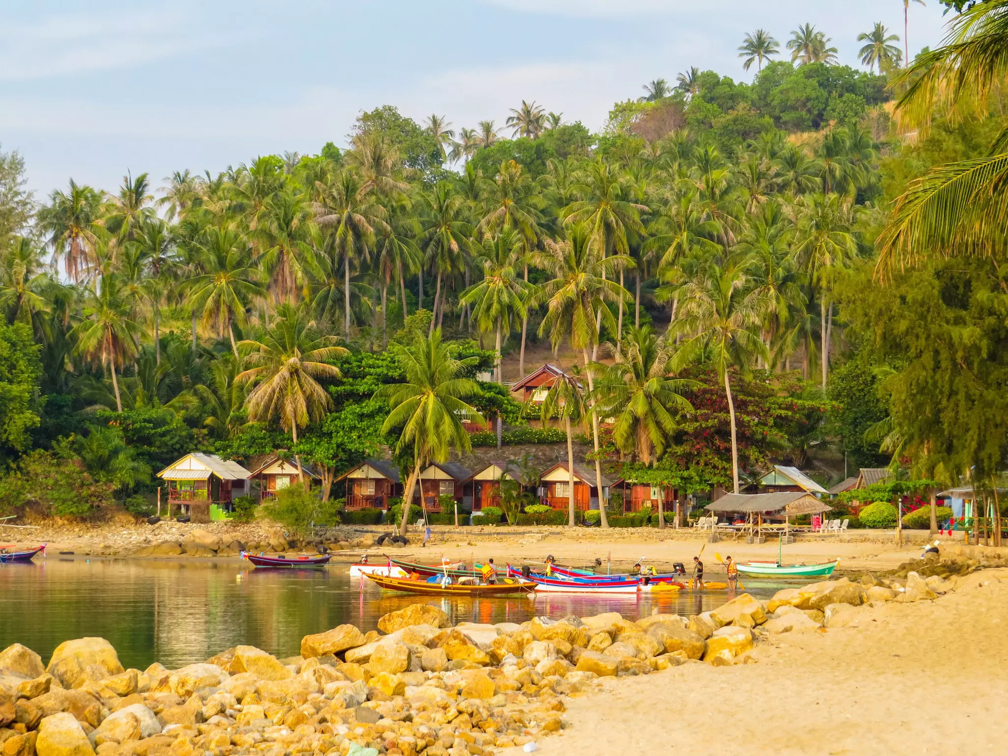 Boats in the water at a beach in Ko Pha-Ngan, Thailand