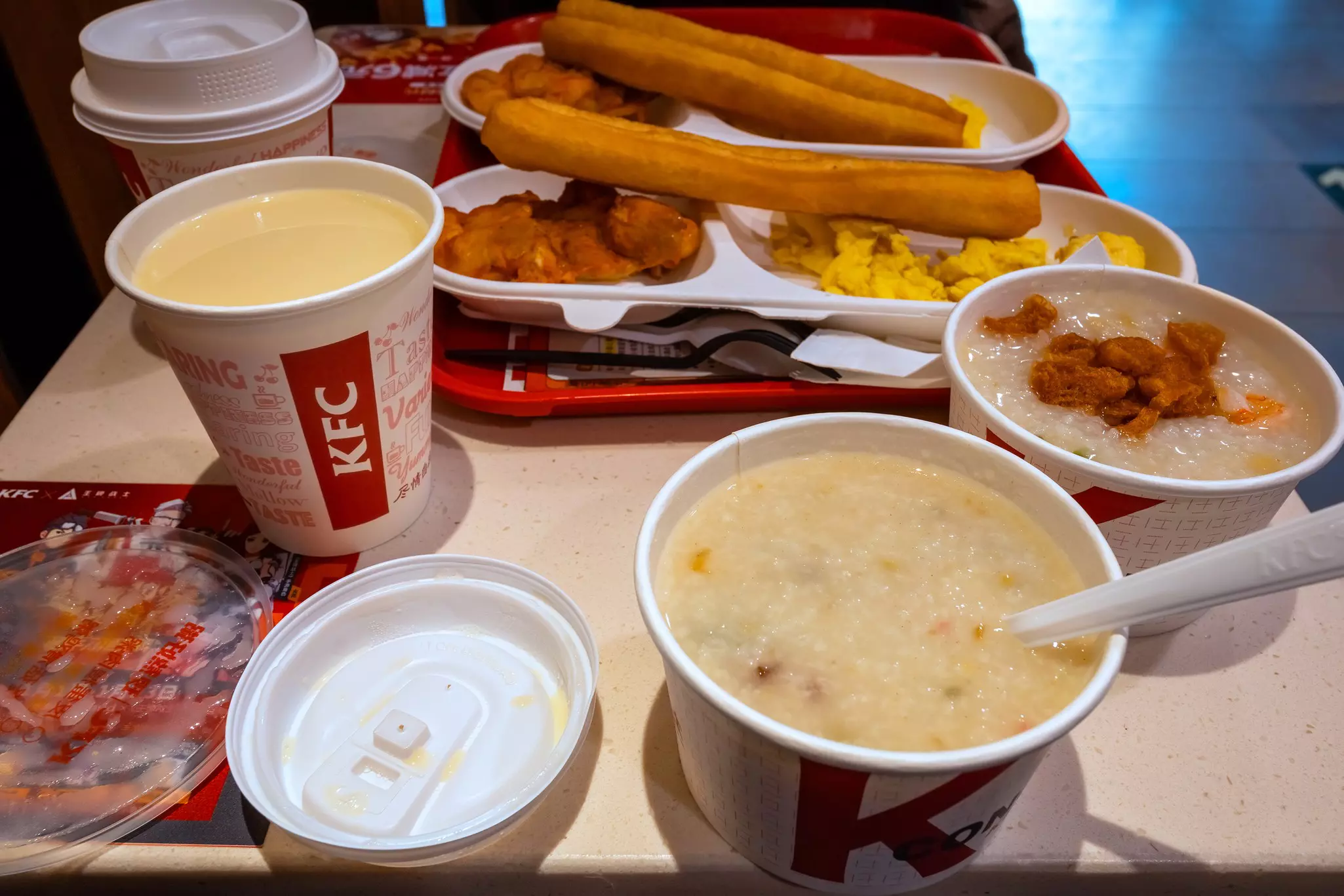 A KFC meal set in Beijing, including congee rice with soy milk, fried dough sticks and spicy grilled chicken.