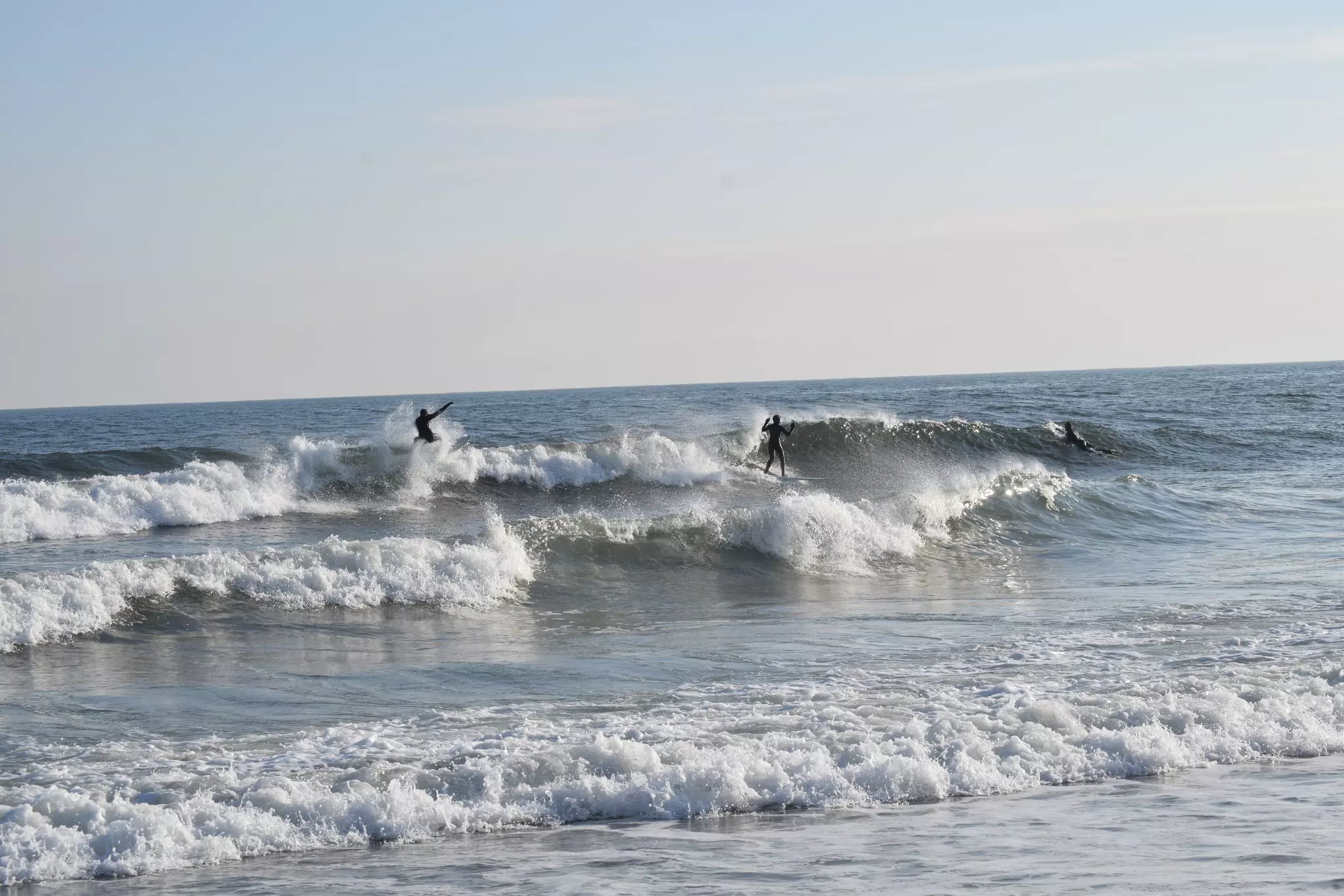 3 surfers at Rockaway Beach