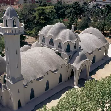 An aerial view of Masia Freixa in Terrassa, built in the Catalan Modernisme style. A white building with arches around its exterior. 