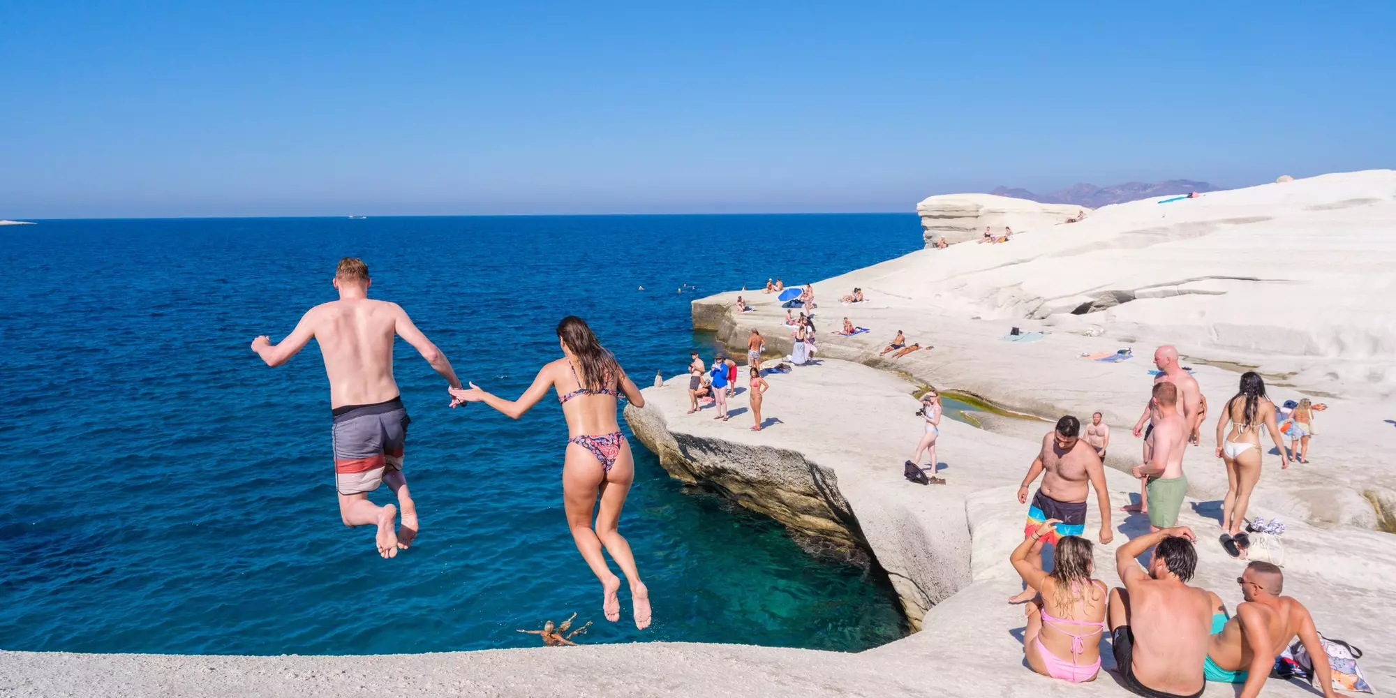 Milos, GR - 28 September 2024: People diving at Sarakiniko beach