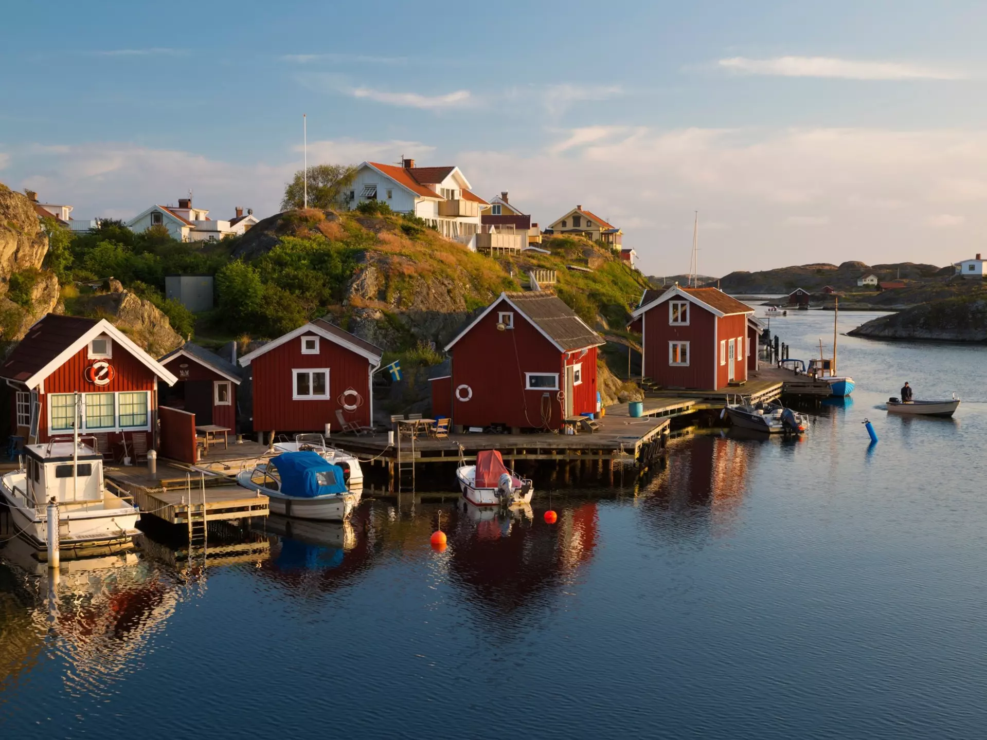 Red huts by a harbor.