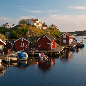 Red huts by a harbor.