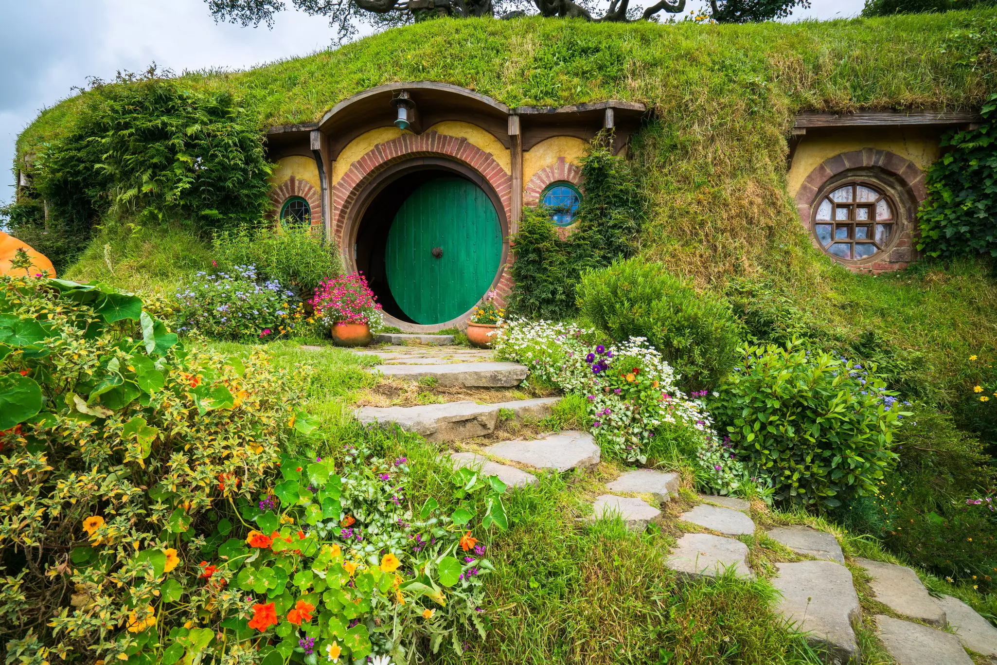 Hobbit holes and hobbit gardens in Hobbiton Movie Set, New Zealand.
