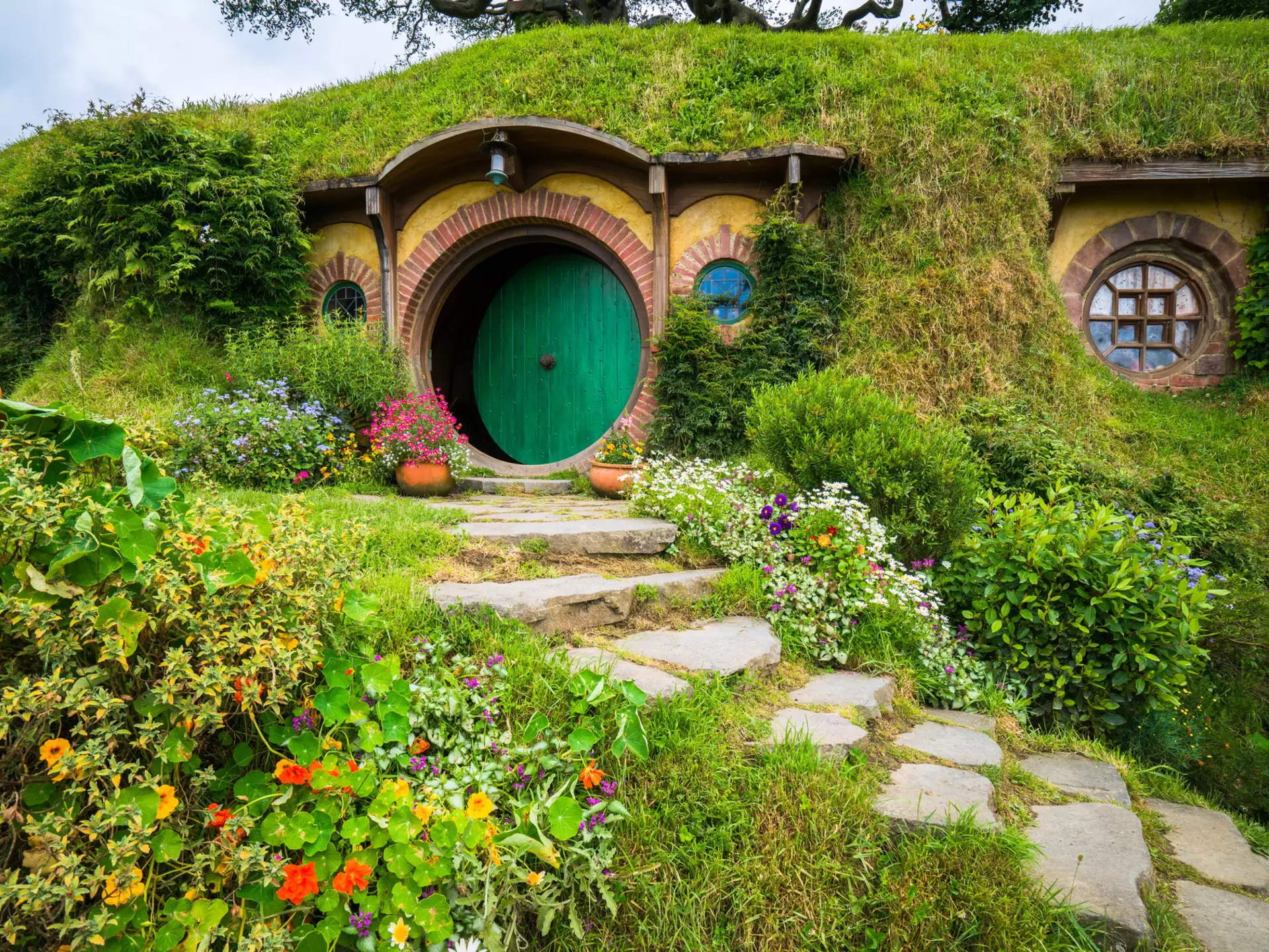 Hobbit holes and hobbit gardens in Hobbiton Movie Set, New Zealand.