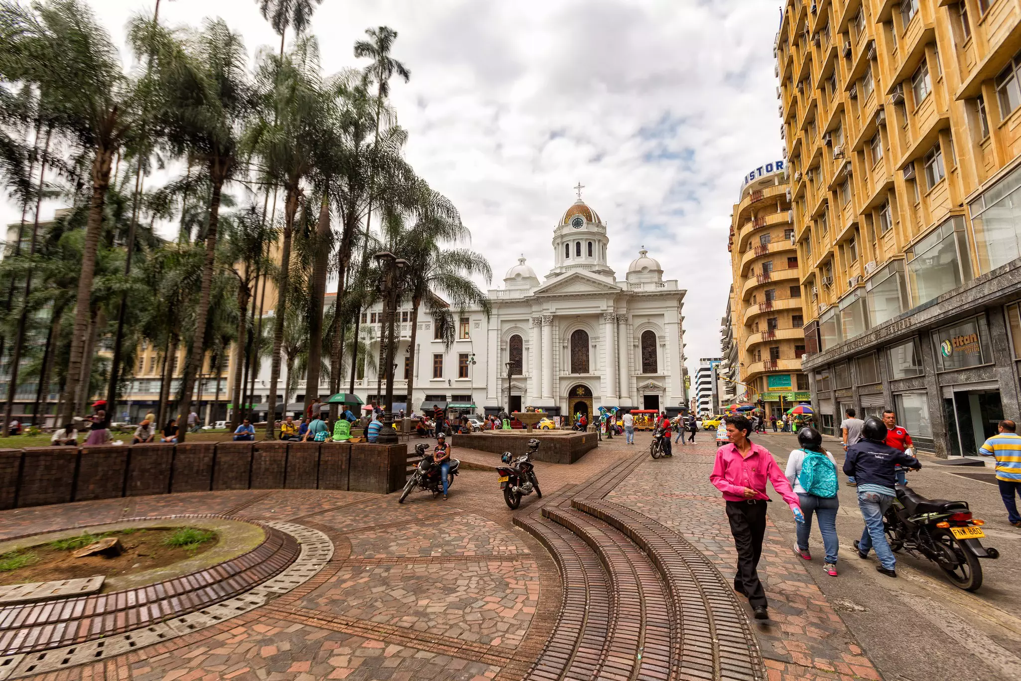People walking through the Plaza de Caicedo in Cali, Colombia