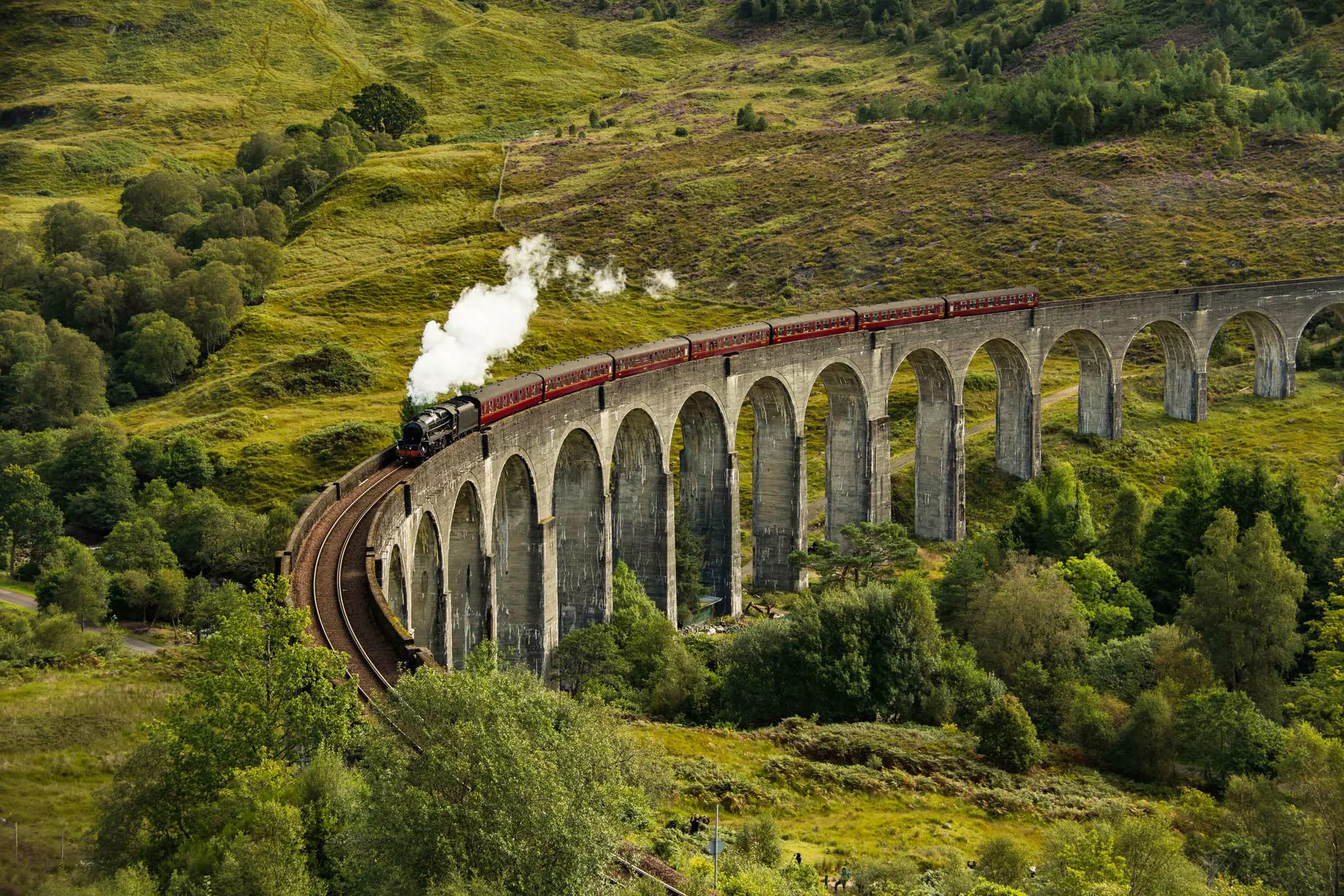 The Jacobite steam train passing over the Glenfinnan Viaduct in Scotland.
