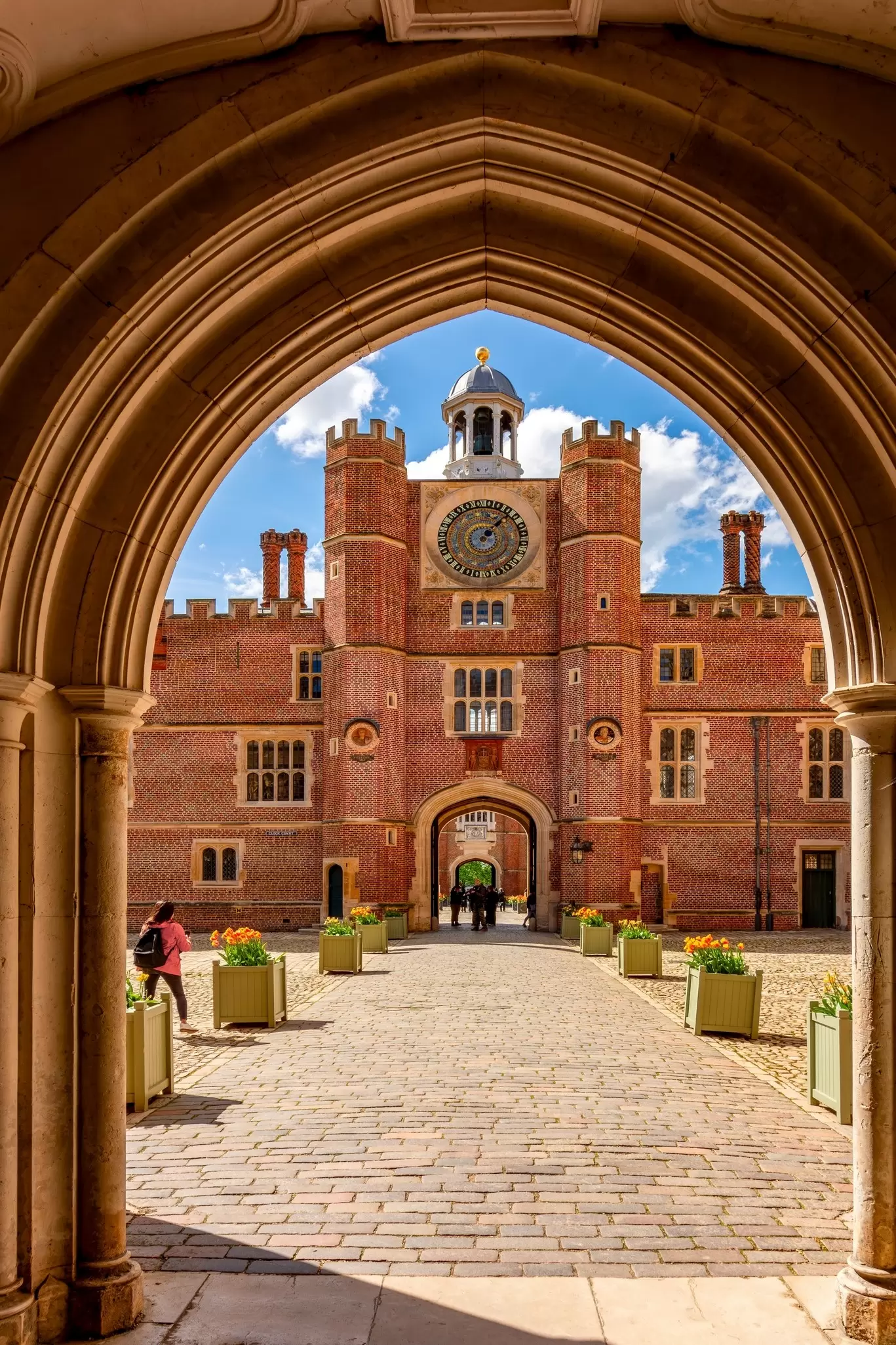 View of the courtyard and astronomical clock at Hampton Court Palace in London, UK.