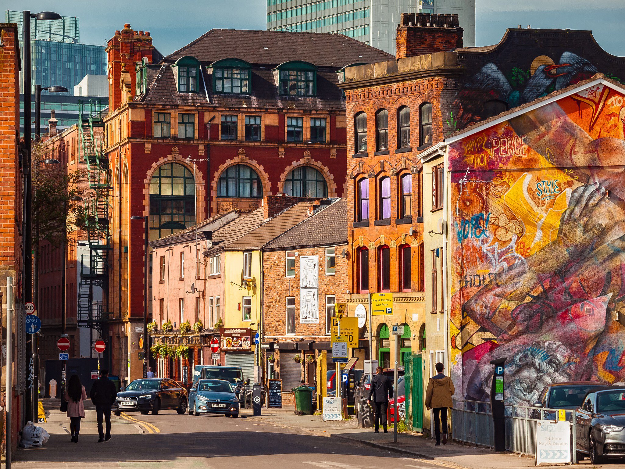 Manchester, England...A view of the Northern Quarter that it is a trendy neighbourhood in Manchester. It is known due tolo the cool stres and restaurants as well as graffitis decorating some buildings.
691837110
person, art, urban, city, building, painting, mural, downtown, road, street
