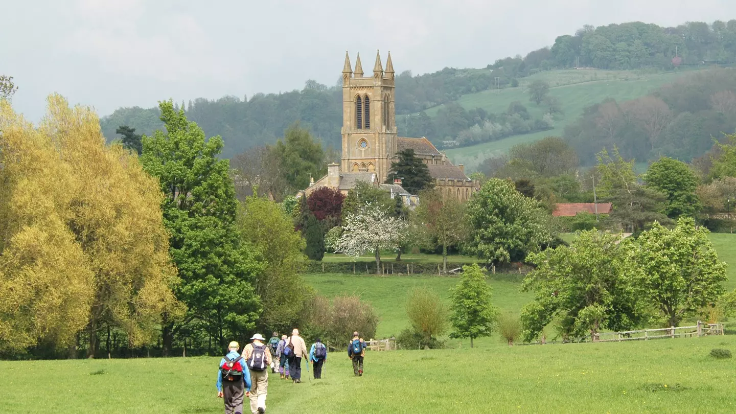 A group of older walkers on the Cotswold Way near Broadway, UK.
