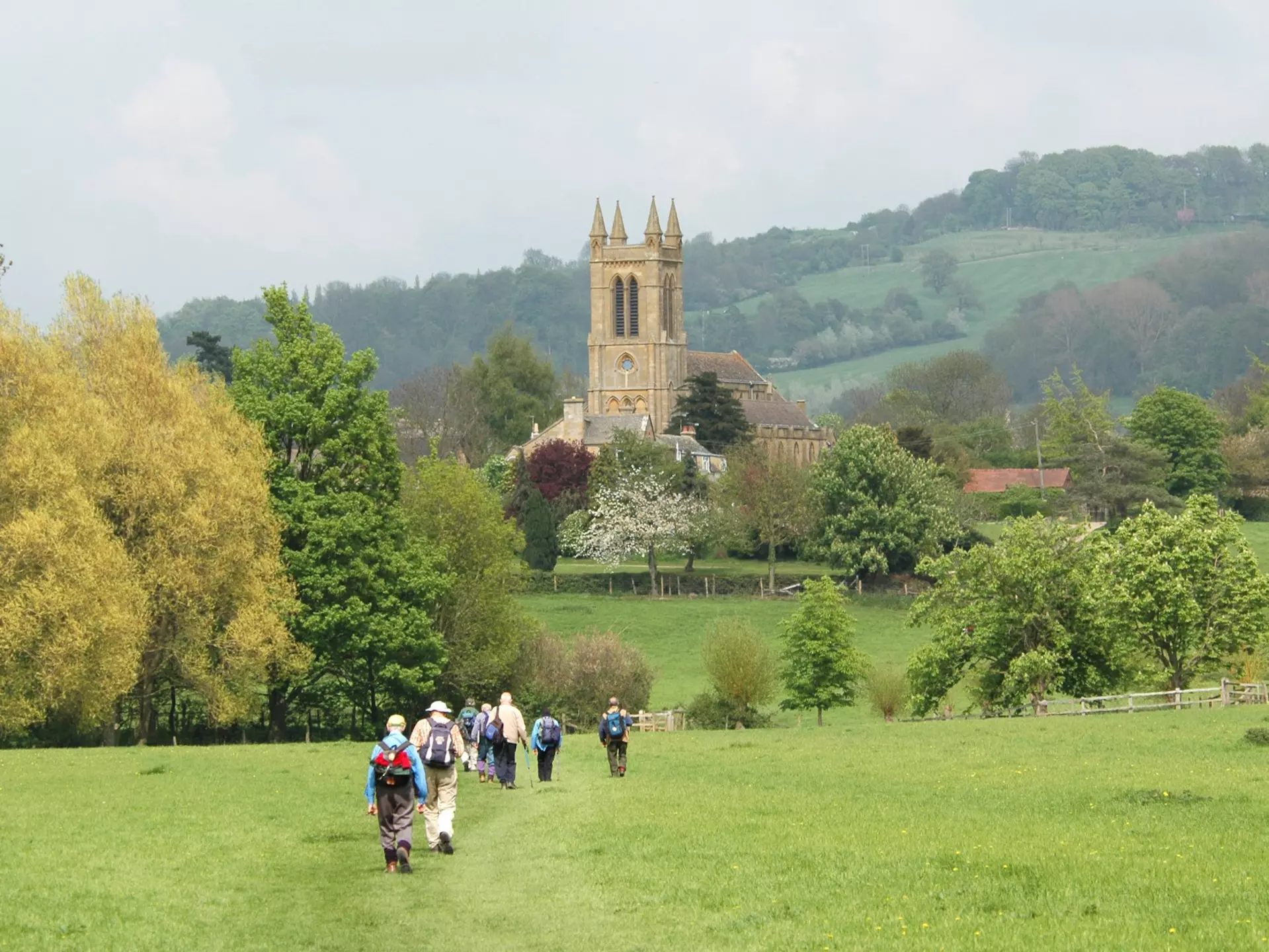 A group of older walkers on the Cotswold Way near Broadway, UK.