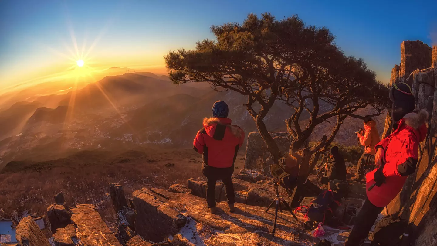 Hiker in Jeollanam-do province at sunrise overlooking the mountains in South Korea
