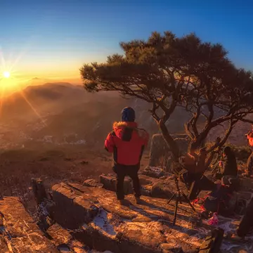 Hiker in Jeollanam-do province at sunrise overlooking the mountains in South Korea