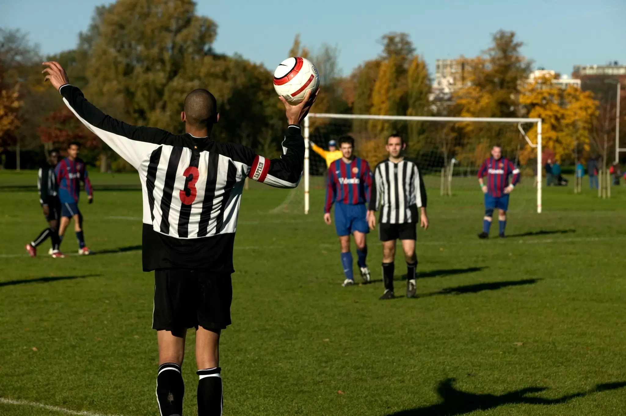 View of a weekend football game being played at Regent's Park in London, UK.