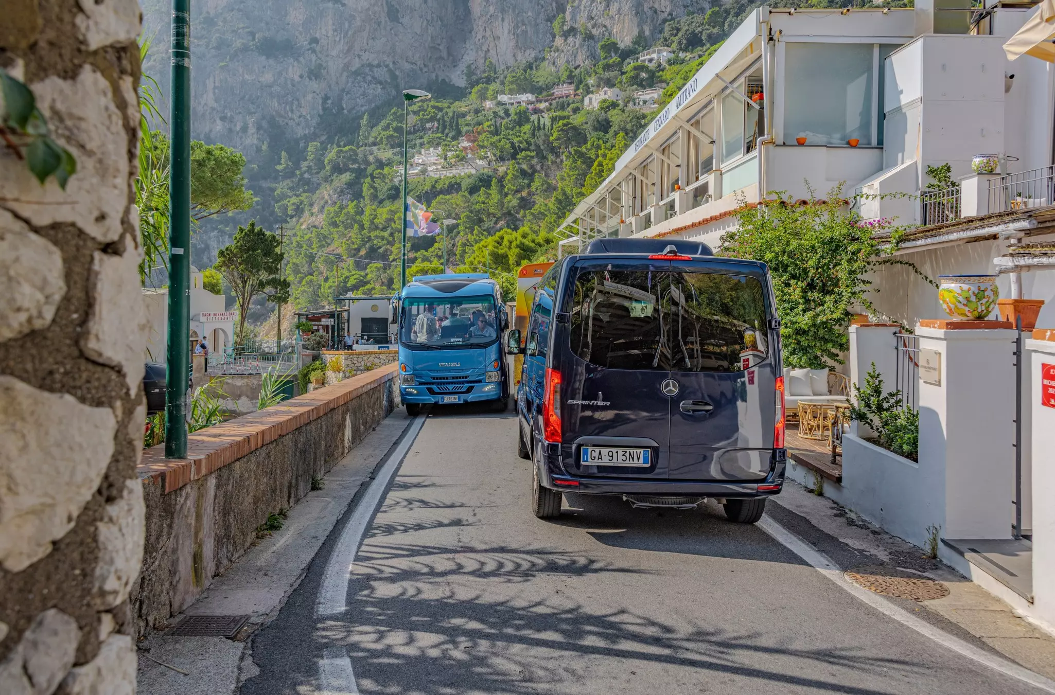 Marina Piccola, Capri, Campania, Italy -- Buses navigating the narrow roads on the Italian island of Capri