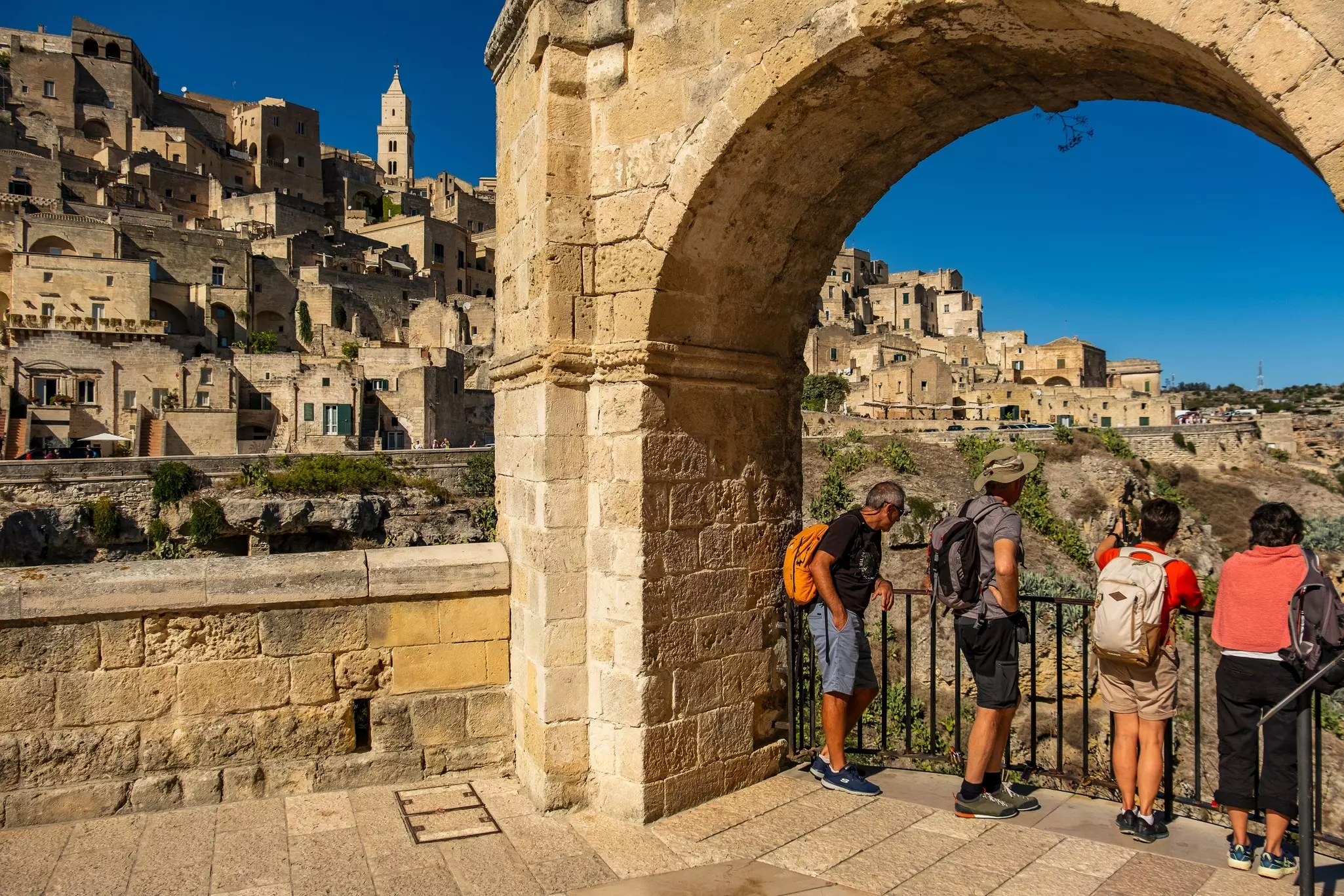 Matera, Basilicata, Italy - October 24 2024: Tourists enjoying the view on the Sassi di Matera, the historic center of Matera, from the San Pietro Caveoso church.