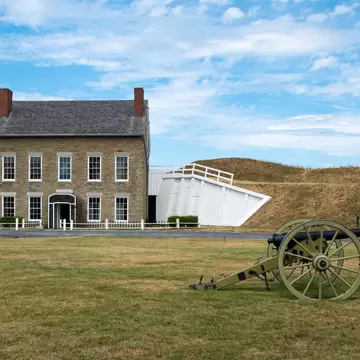 The Headquarters of old revolutionary war Fort Ontario, with a cannon in the foreground in Toronto, Canada.