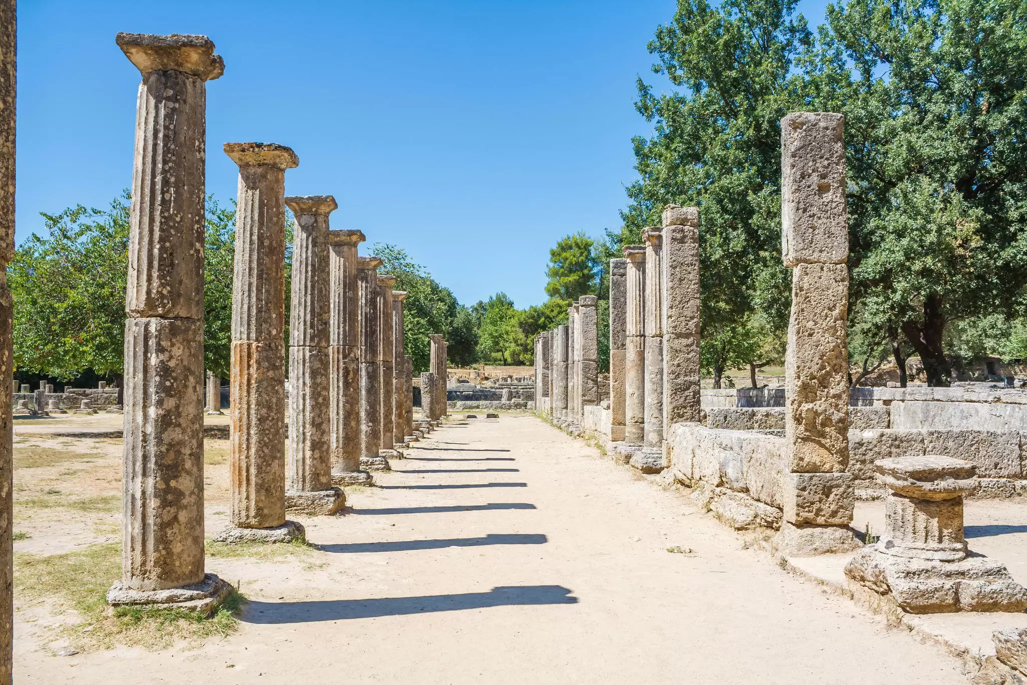 View of a corridor of columns at the archaeological site of Ancient Olympia, Greece.