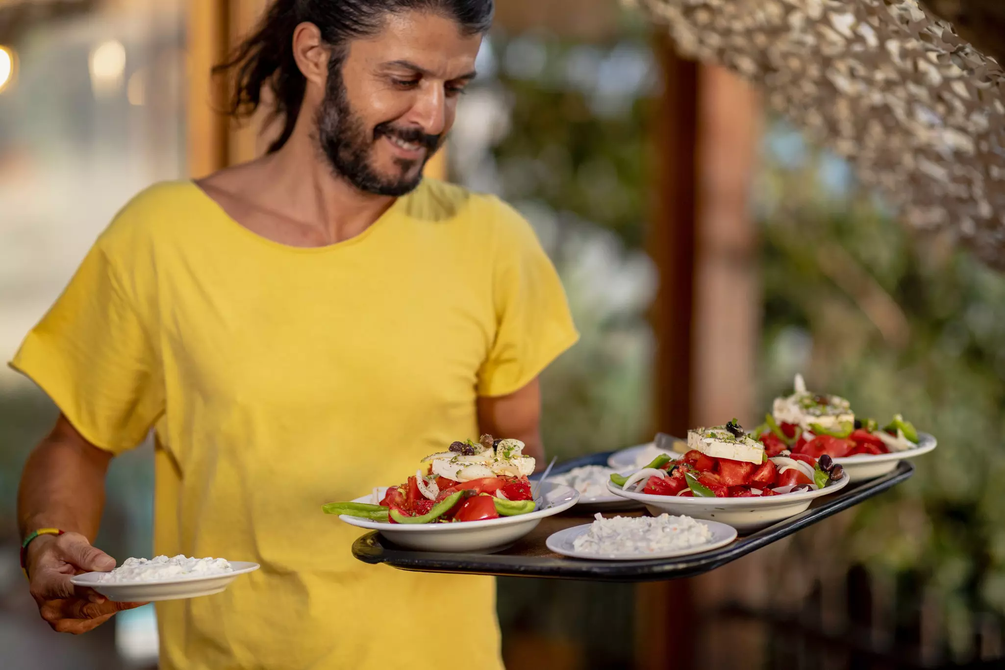The joy of dinning in Greece is inextricably linked to traditional social rituals, religious festivals, and celebrations © SolStock / Getty Images