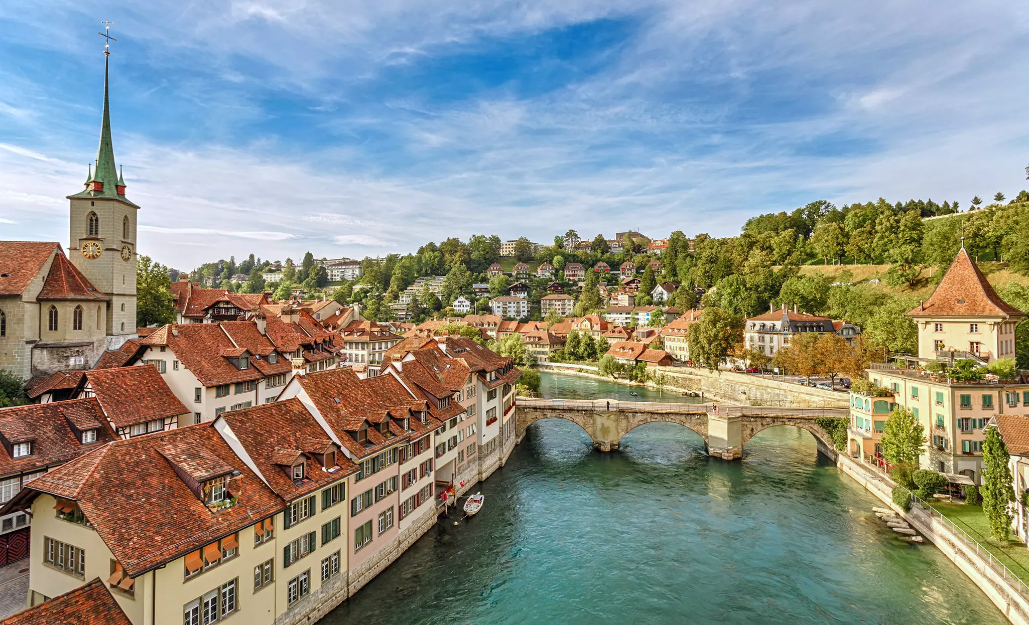 A view of old town buildings by a river in Switzerland.