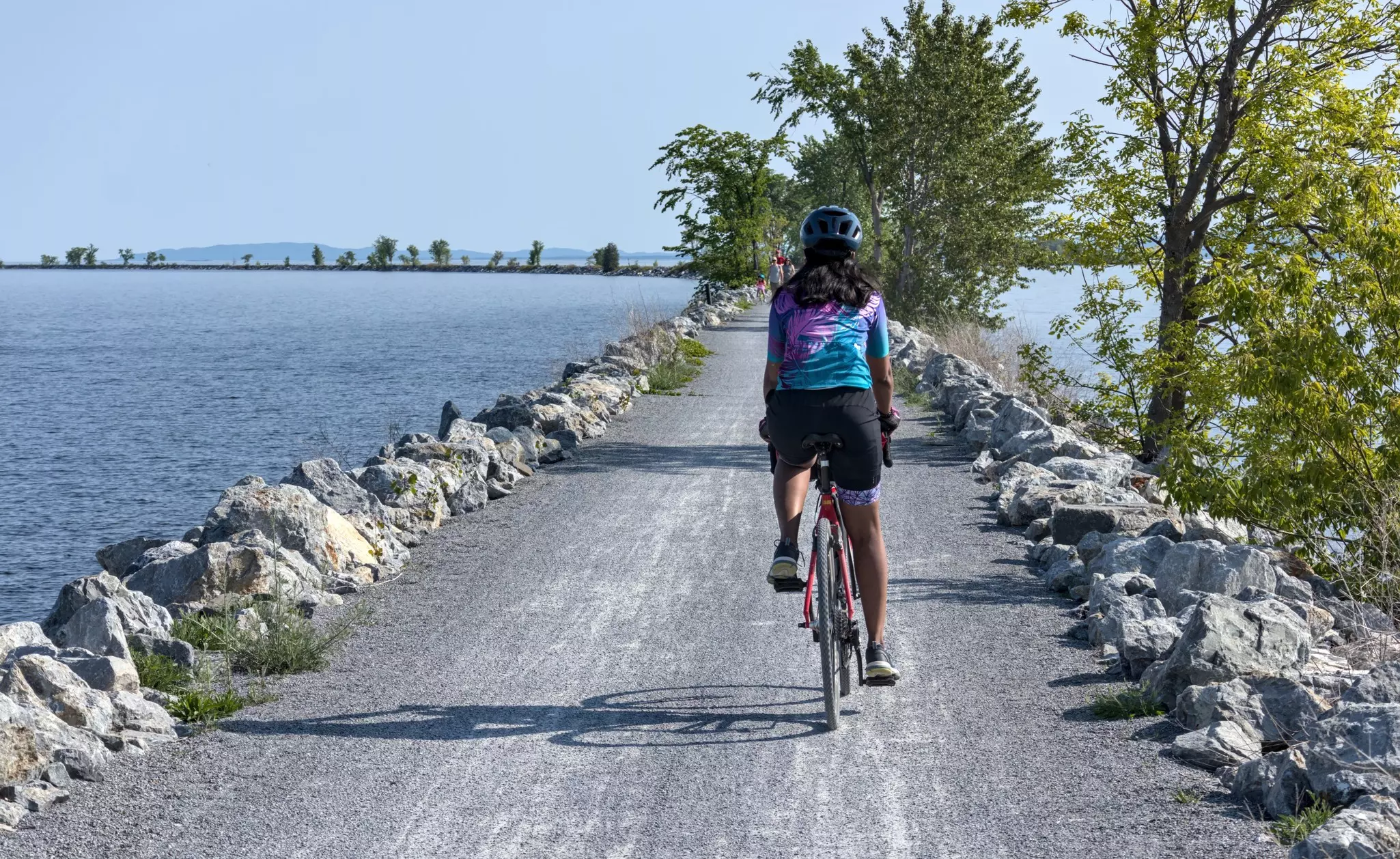 Cyclists ride on the Colchester Causeway on Lake Champlain in Vermont