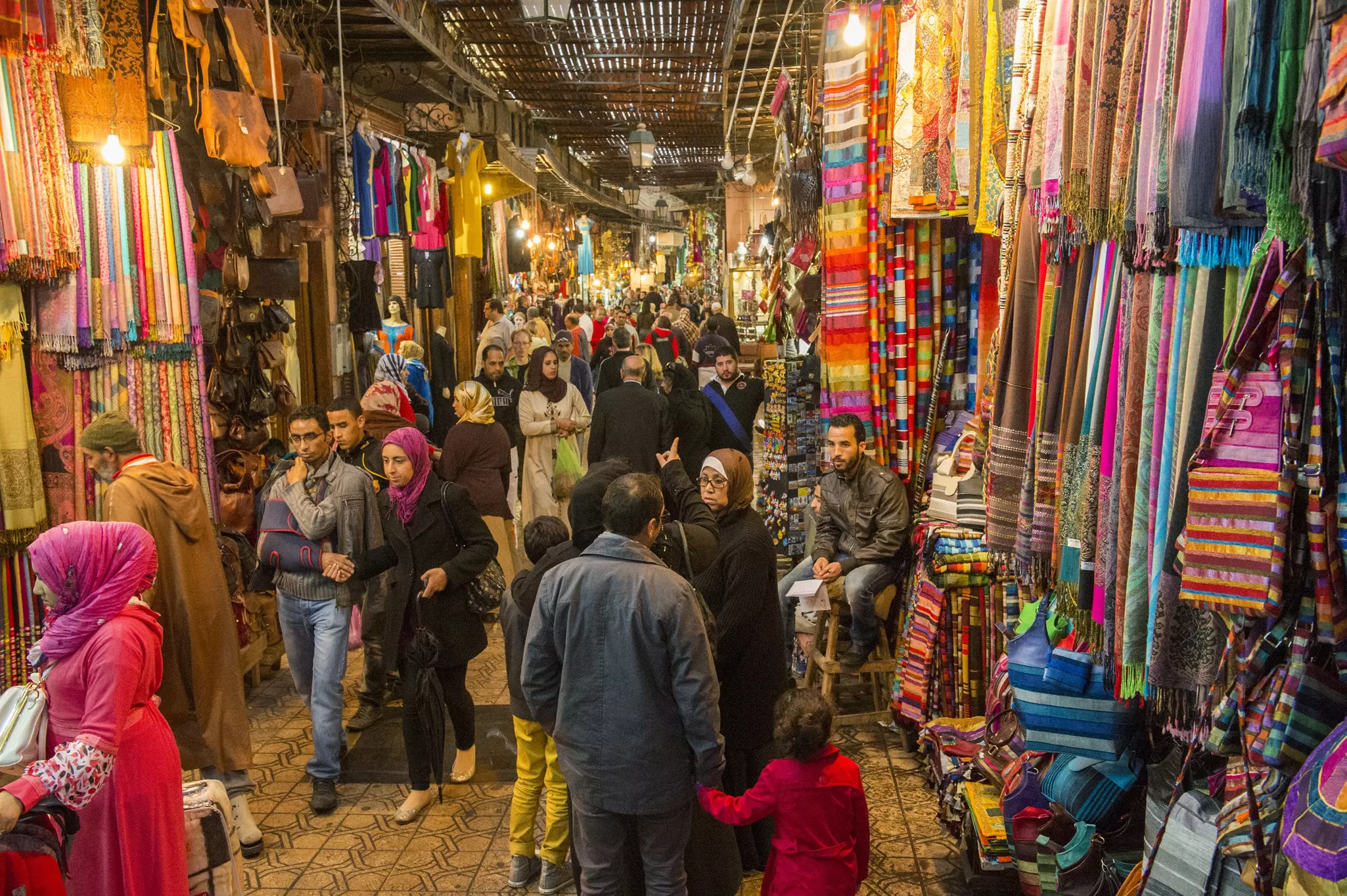 JEMMA DAR FNA, THE MAIN BAZAAR, People walking on a corridor surrounded by booths and stalls in Jemma Dar Fna, Marrakech, Morocco