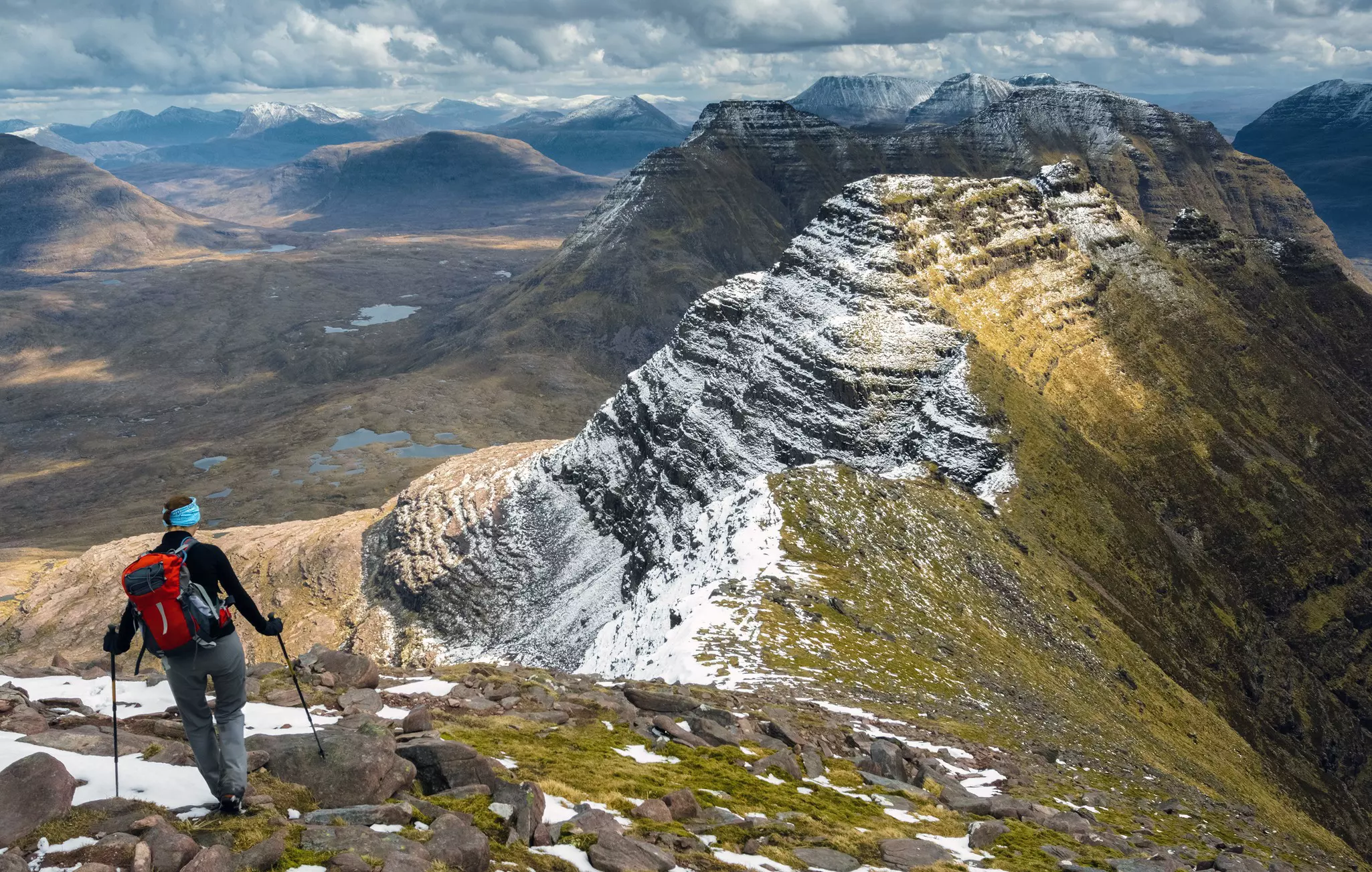 A hiker on Ben Alligin Ridge in the Torridon Mountains in the Scottish Highlands.