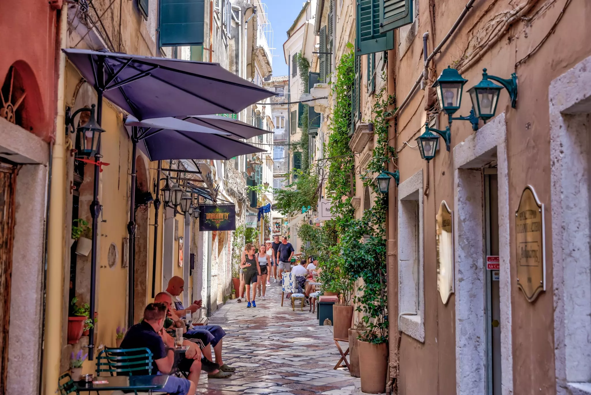 Cityscapes and traditional architecture of Corfu Town in Greece with tourists enjoying the sights