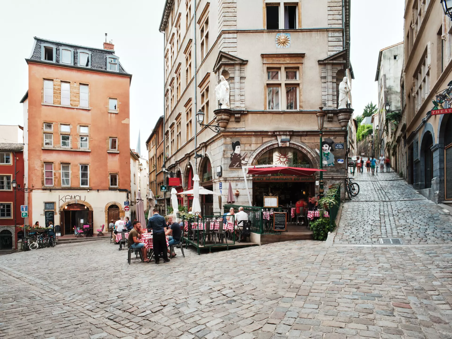 People dining outside in the early evening at restaurants in Lyon
