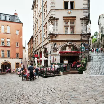 People dining outside in the early evening at restaurants in Lyon