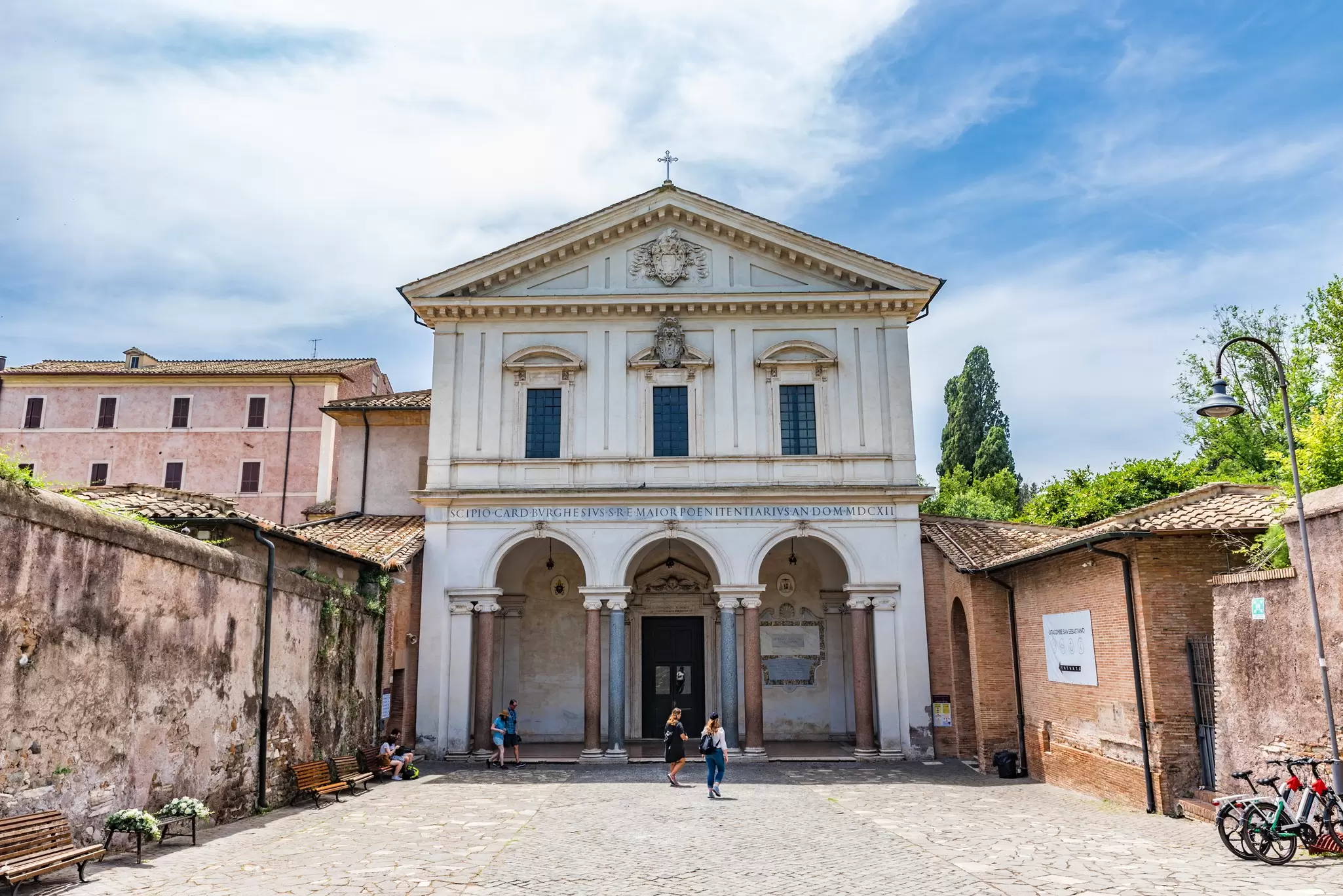 A large white church building, the entrance to catacombs