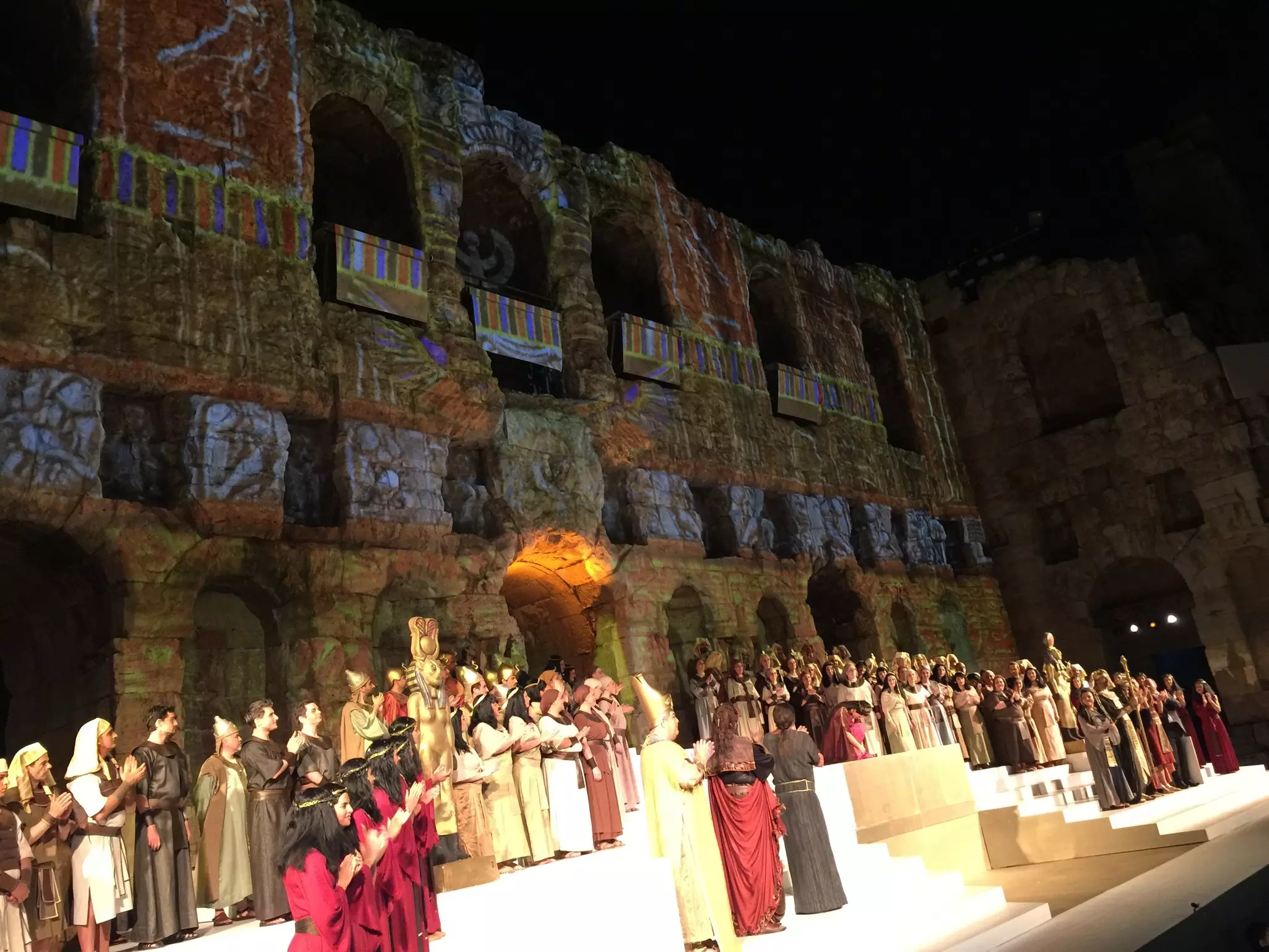 Costumed performers in an ancient amphitheater.