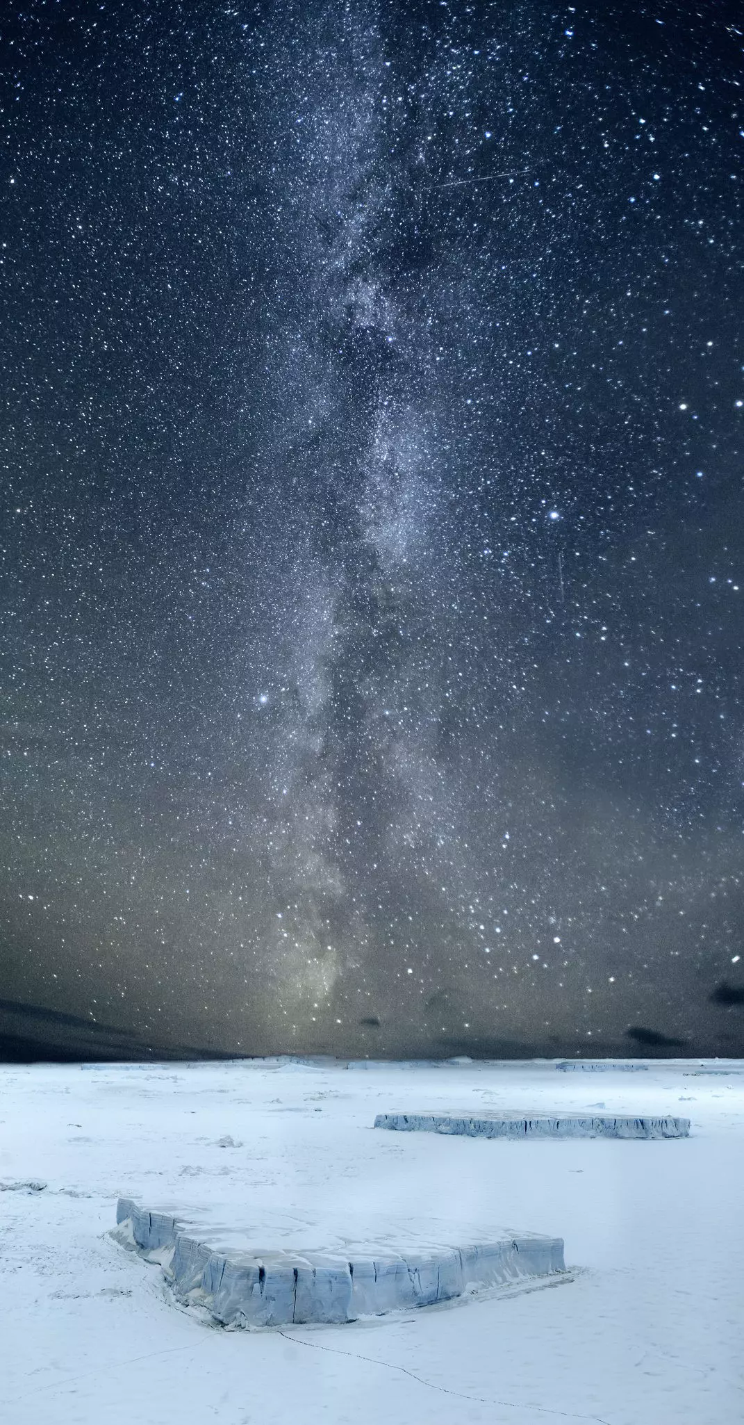 The Milky Way over Antarctica, with millions of stars in the dark sky above a white snowy landscape