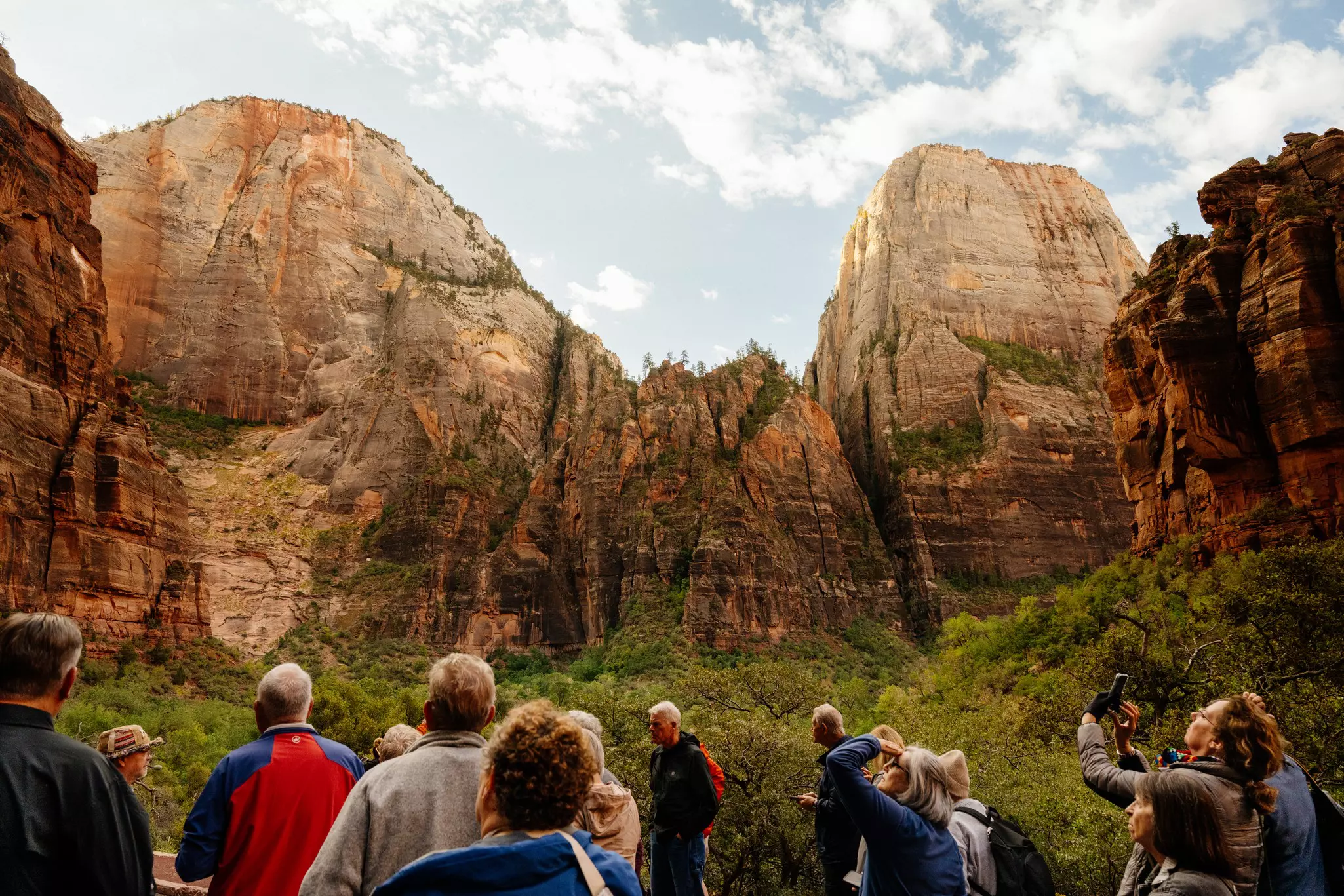 Walkers admire the landscape in Zion National Park, Utah, USA.