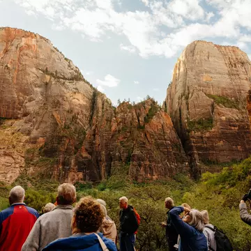 A group of people walking through Zion National Park.