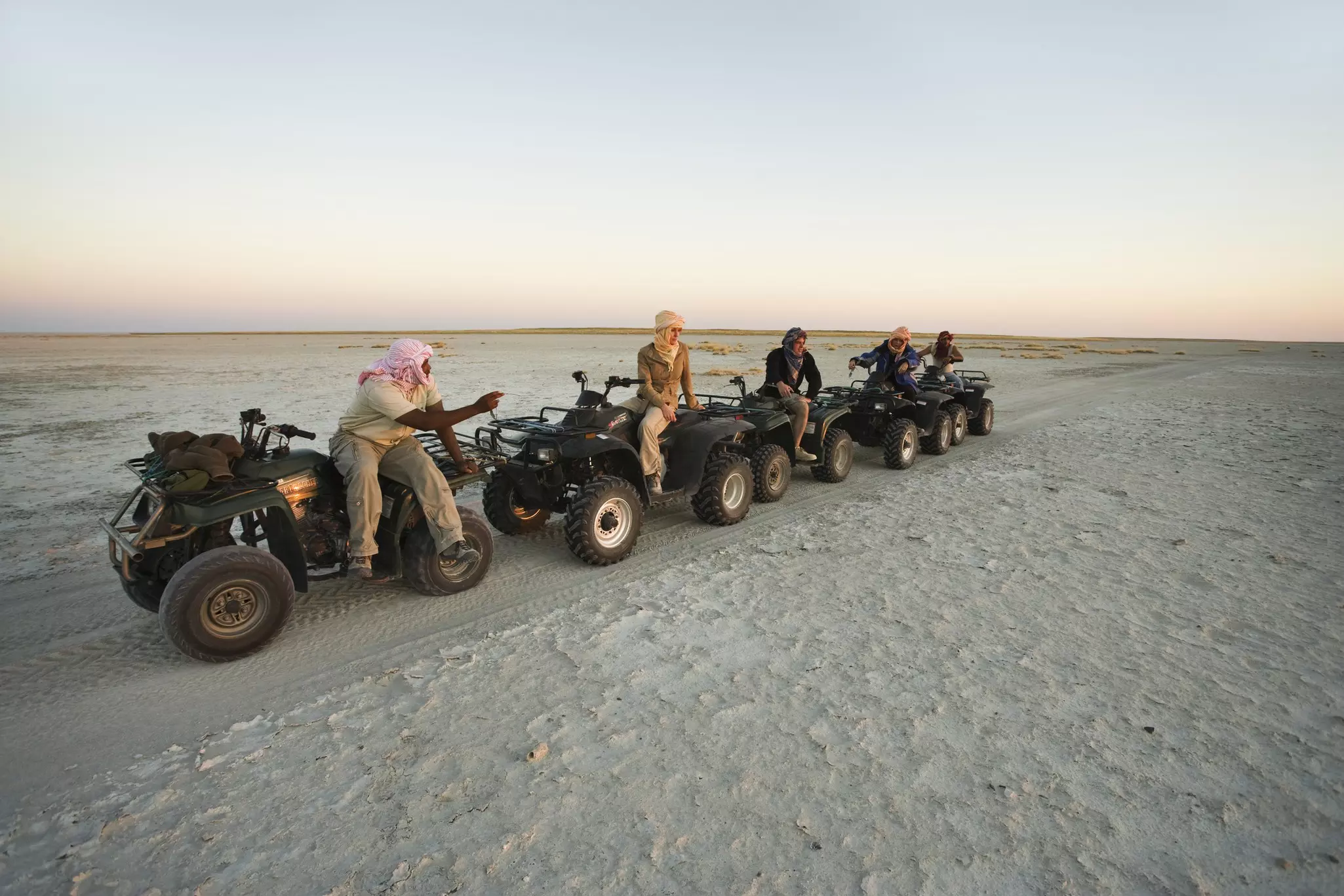 Tourists explore Botswana's salt flats on quad bikes