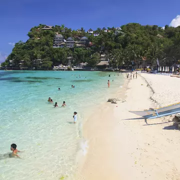 People enjoying the white sands of Boracay Island in the Philippines.