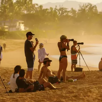 Pupukea, Oahu, Hawaii - November 05, 2019: sunset beach at the North Shore with unidentified people. This area is best known for its massive waves, attracting surfers from all around the globe, License Type: media, Download Time: 2026-05-21T16:49:48.000Z, User: lonelyplanetmedia, Editorial: true, purchase_order: 65050 - Digital Destinations and Articles, job: Comp Ingestion, client: Global Publishing WIP, other: Pia Peterson