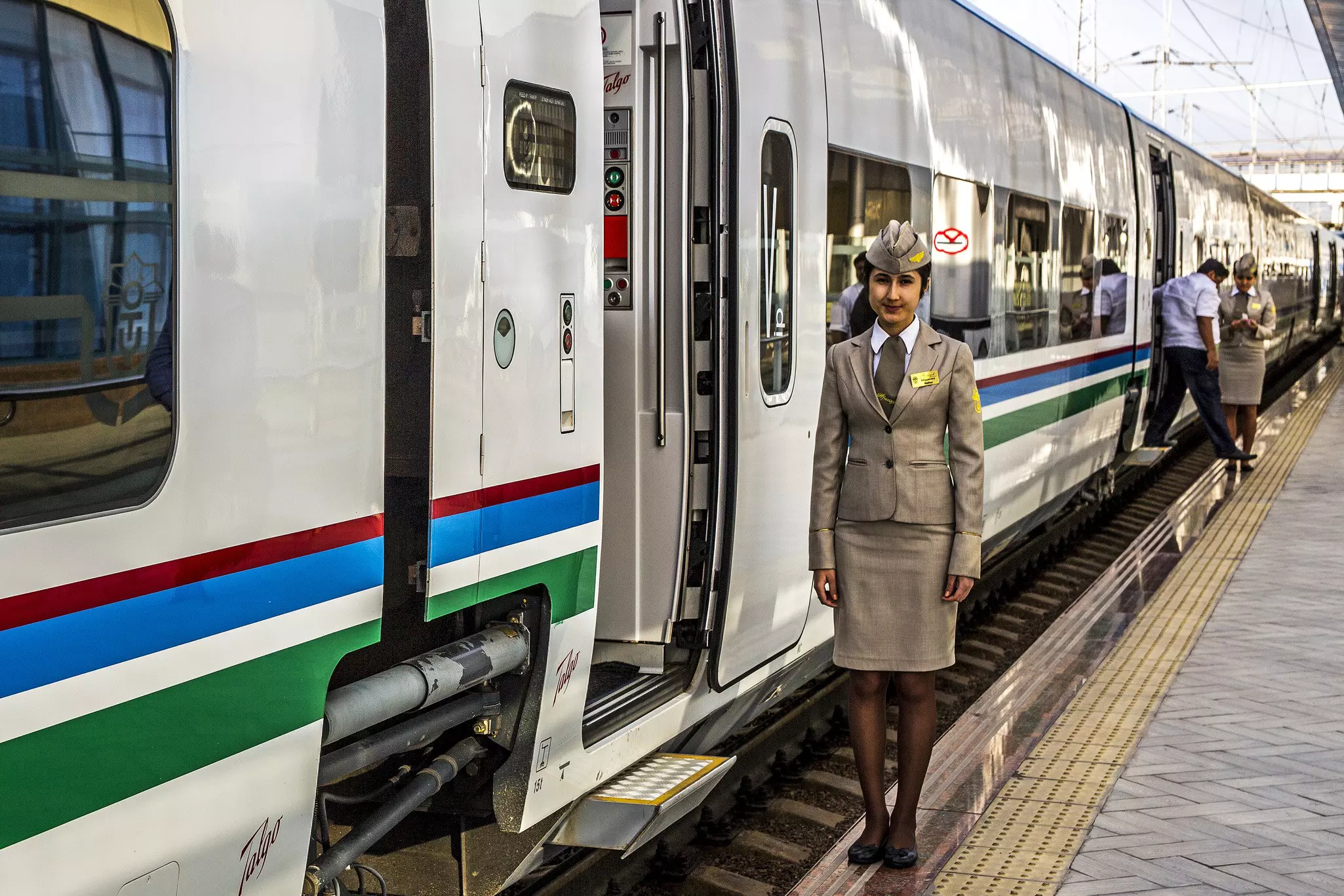 Female train conductor by the Afrosiyob train door